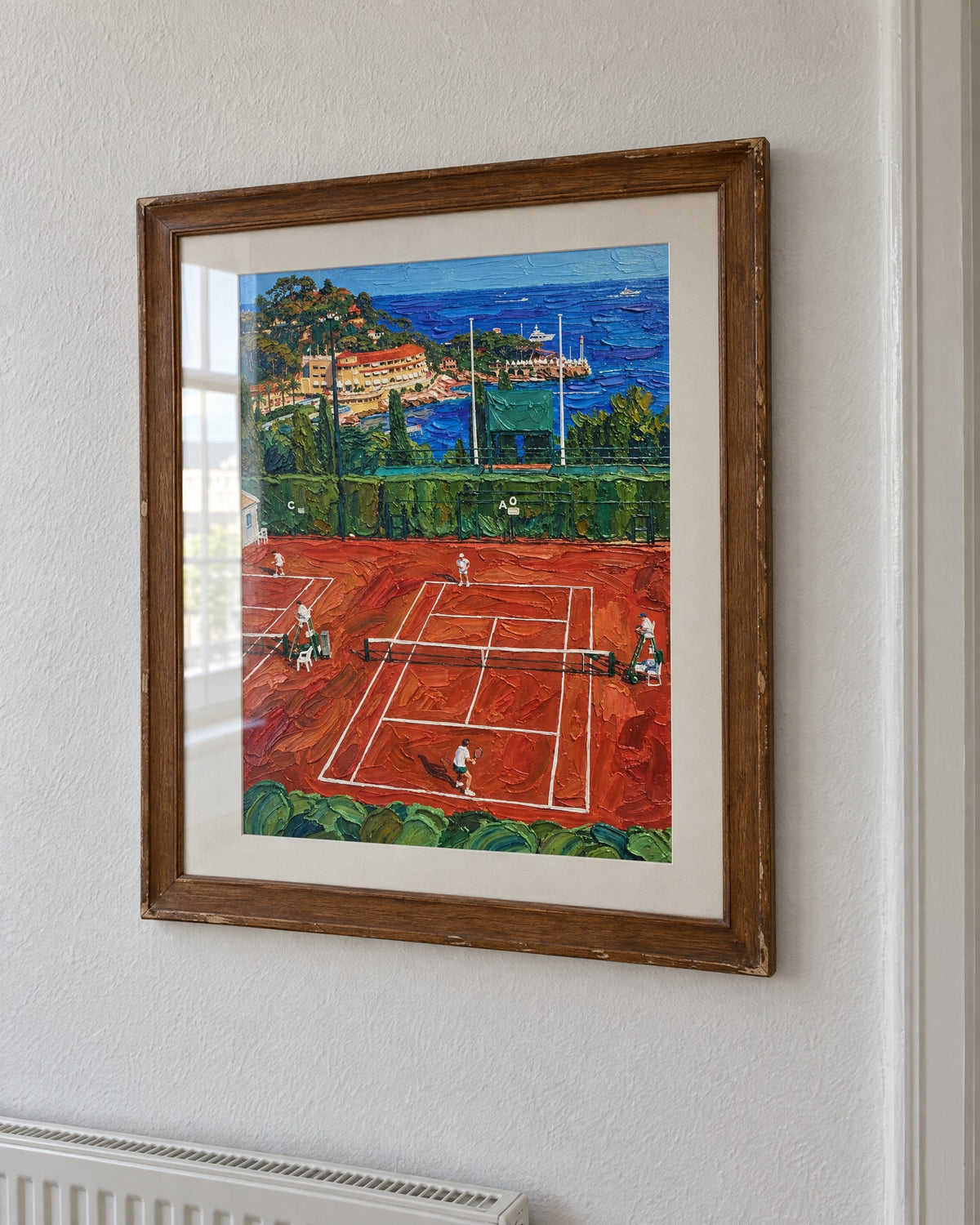 Print in an old oak frame with a mat, on a white wall